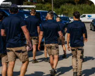 Plumbers walking to their service vans on a Greenwich job